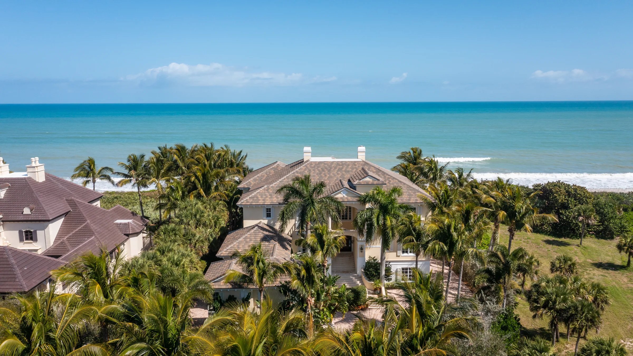 211 Beachside Drive from above: terra-cotta roof and oceanfront positioning at the south end of the barrier-island oceanfront row