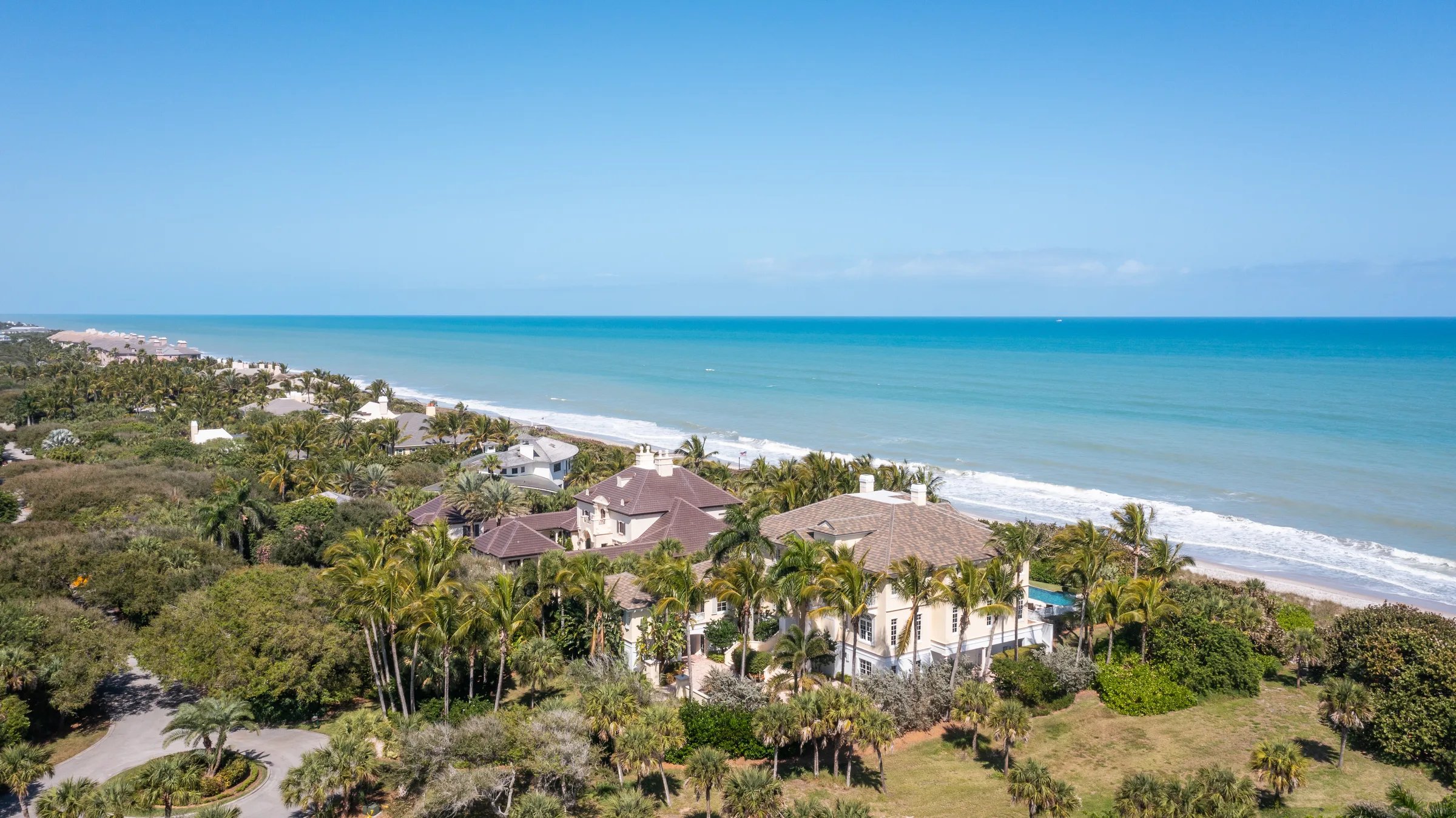 Wide aerial of 211 Beachside Drive estate and the Orchid Island shoreline along the Atlantic in Orchid, Florida