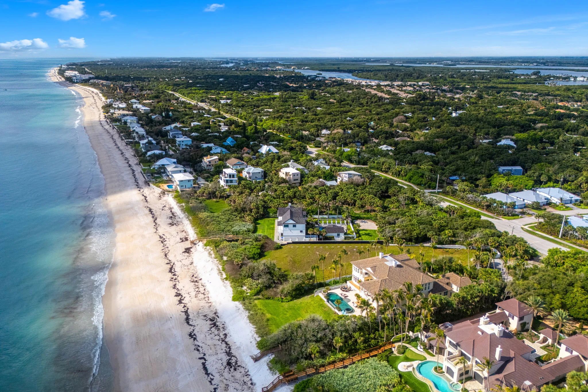 High aerial along the Treasure Coast showing Orchid Island barrier island, private estates and the Atlantic shoreline stretching south toward Vero Beach
