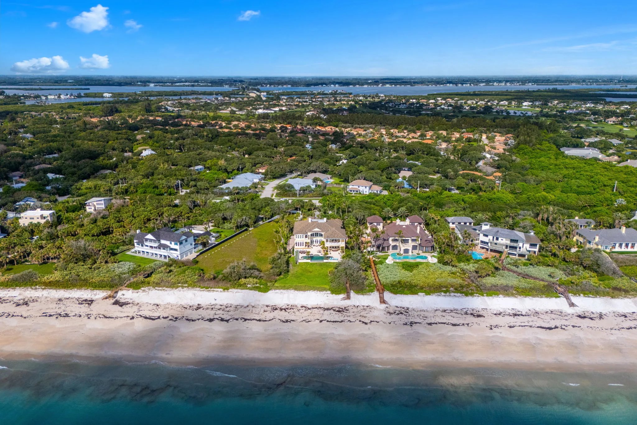 Aerial coastline view of Orchid showing 211 Beachside Drive between neighboring estates with Indian River Lagoon in distance