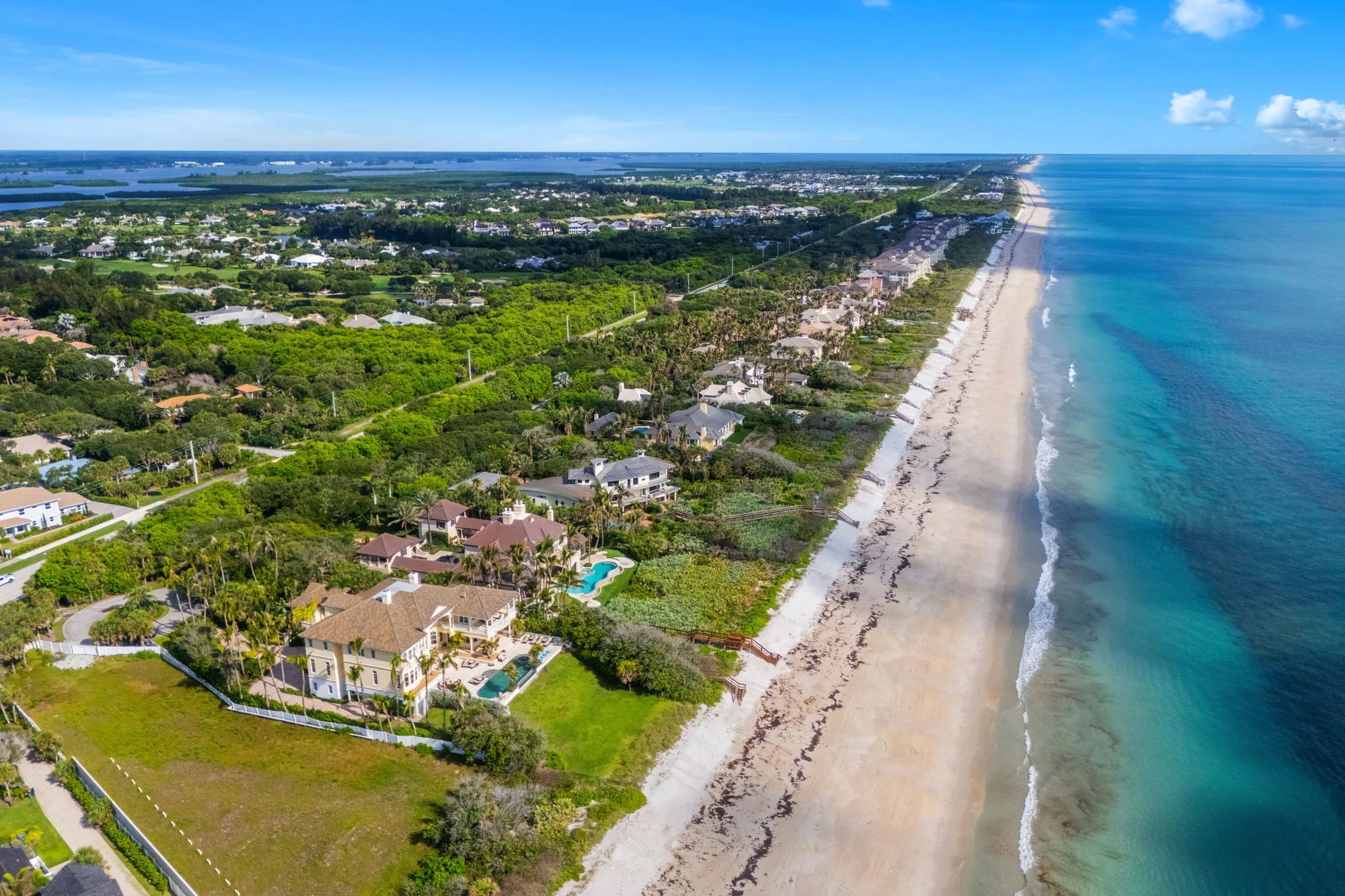 Aerial north along the Orchid coastline showing the estate set on the Atlantic shore