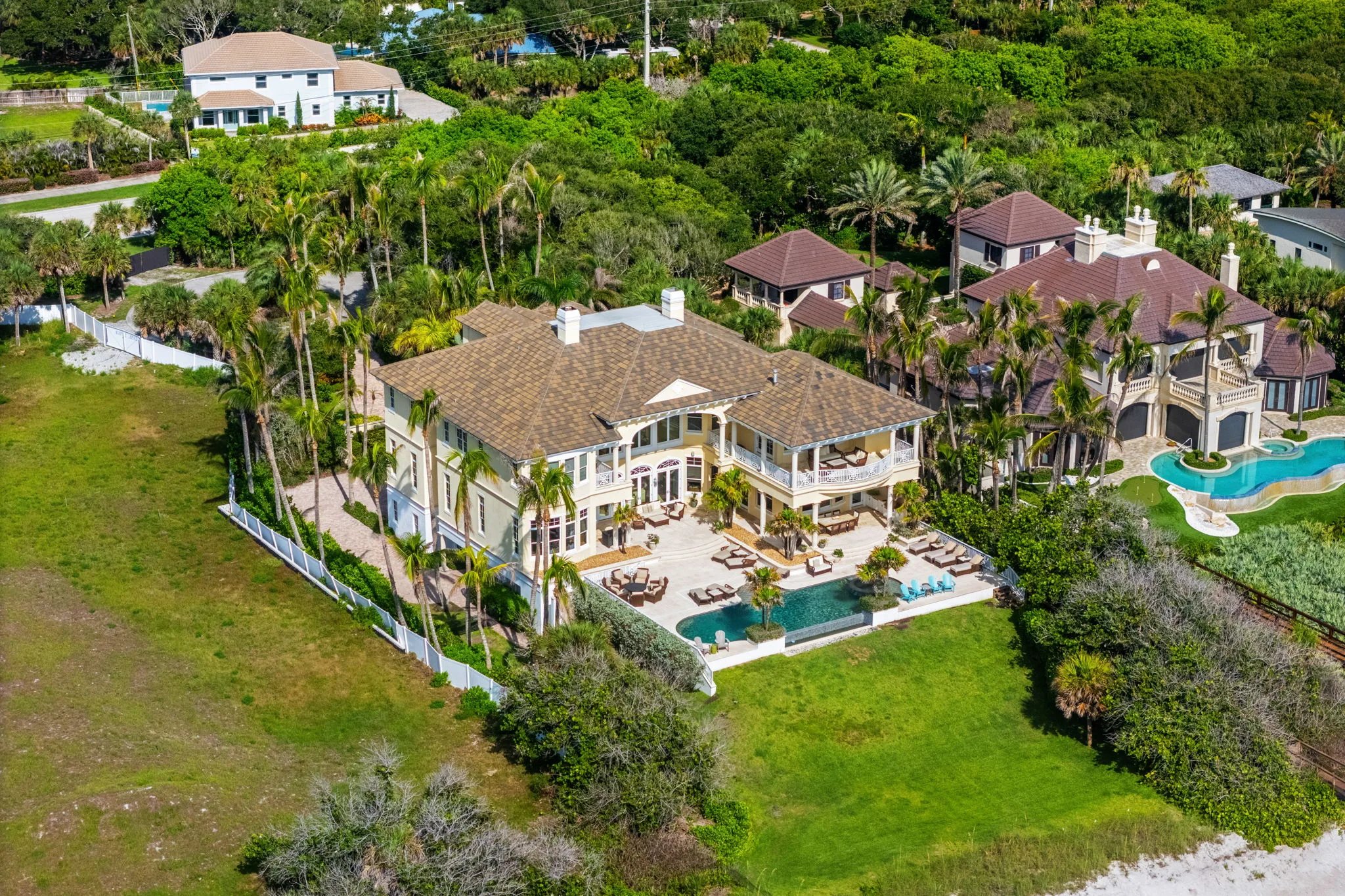 Aerial view of the rear terrace, pool, and neighboring estates near the Atlantic