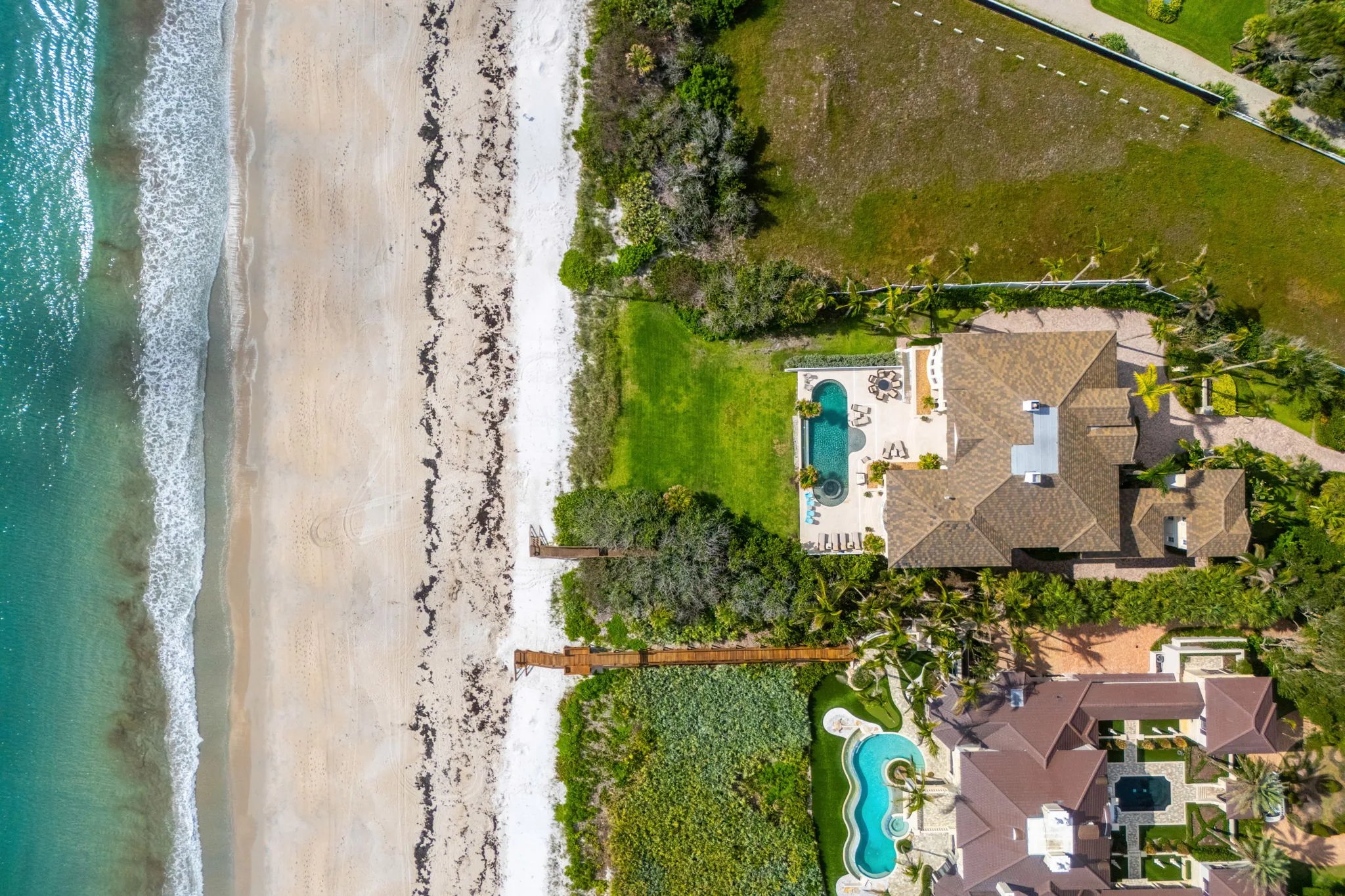 Top-down aerial of the estate, boardwalk, and Atlantic beach