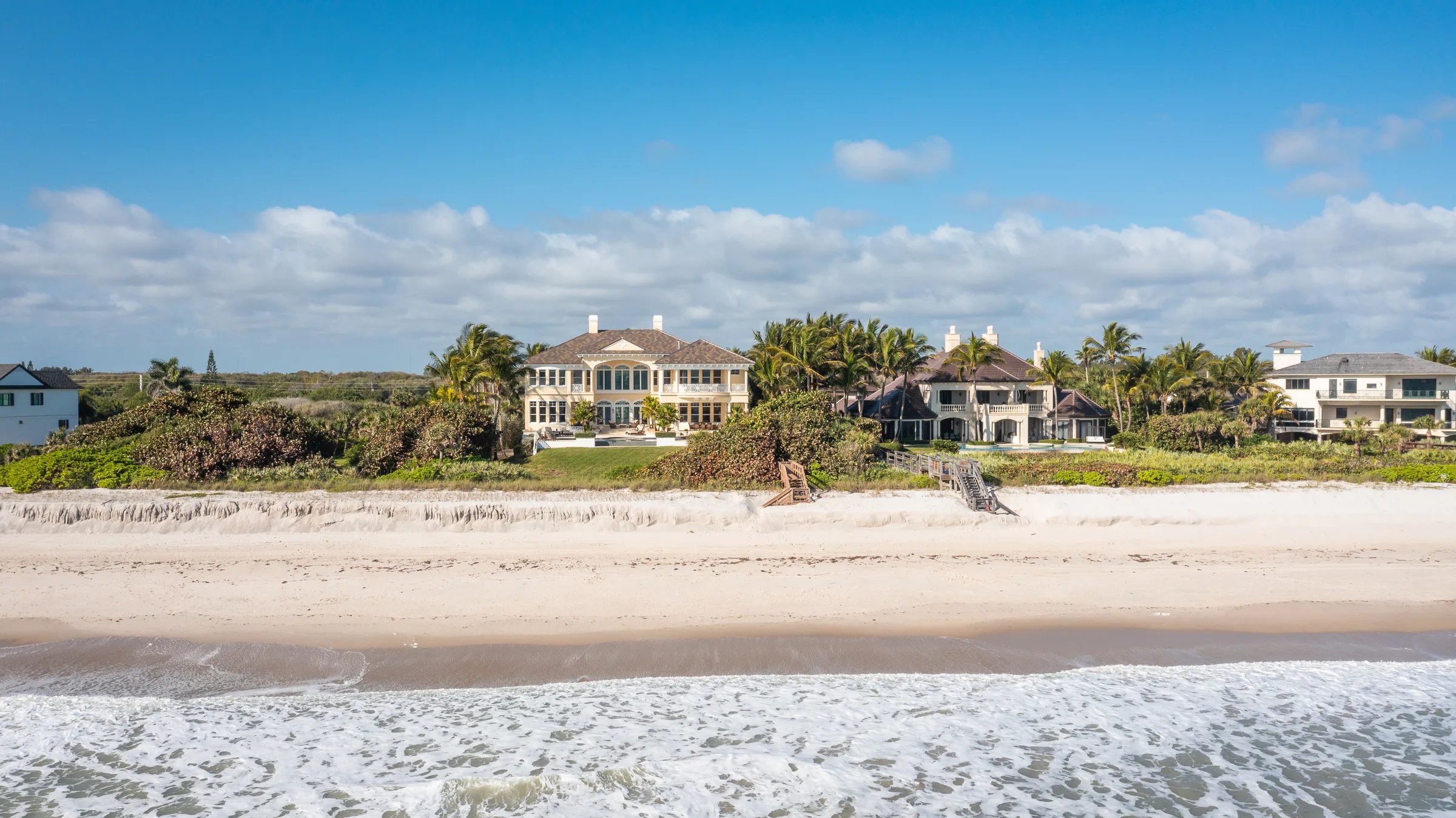 Aerial of the Atlantic coastline along Orchid Island showing 211 Beachside Drive between neighboring oceanfront estates