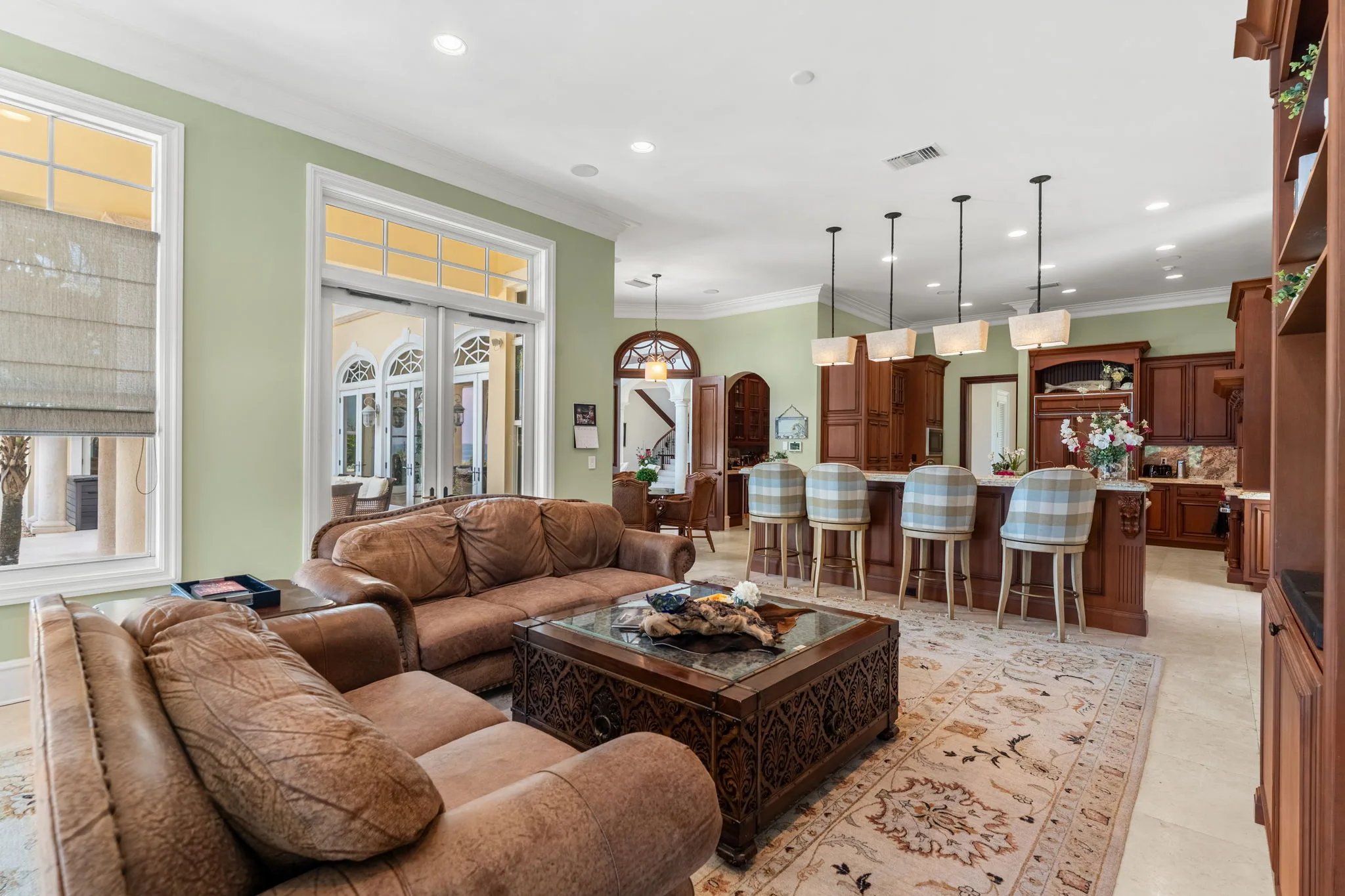Family room sectional opens to the kitchen breakfast bar with ocean light