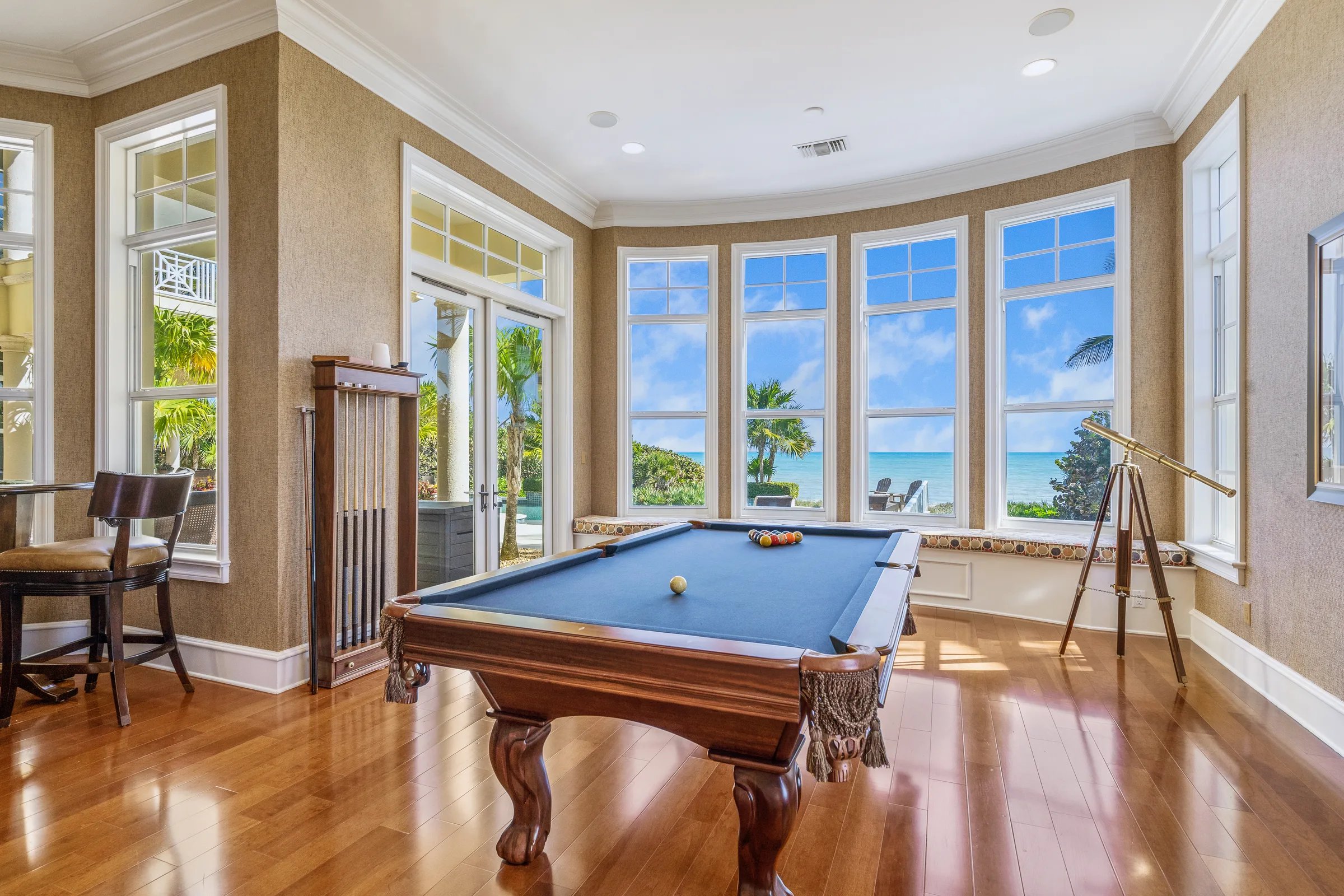 Billiards room with bay windows to ocean and French doors