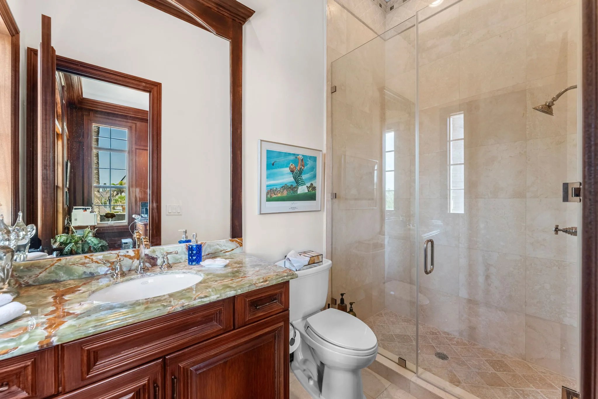 Guest bath with green onyx vanity, mahogany trim, and walk-in glass shower