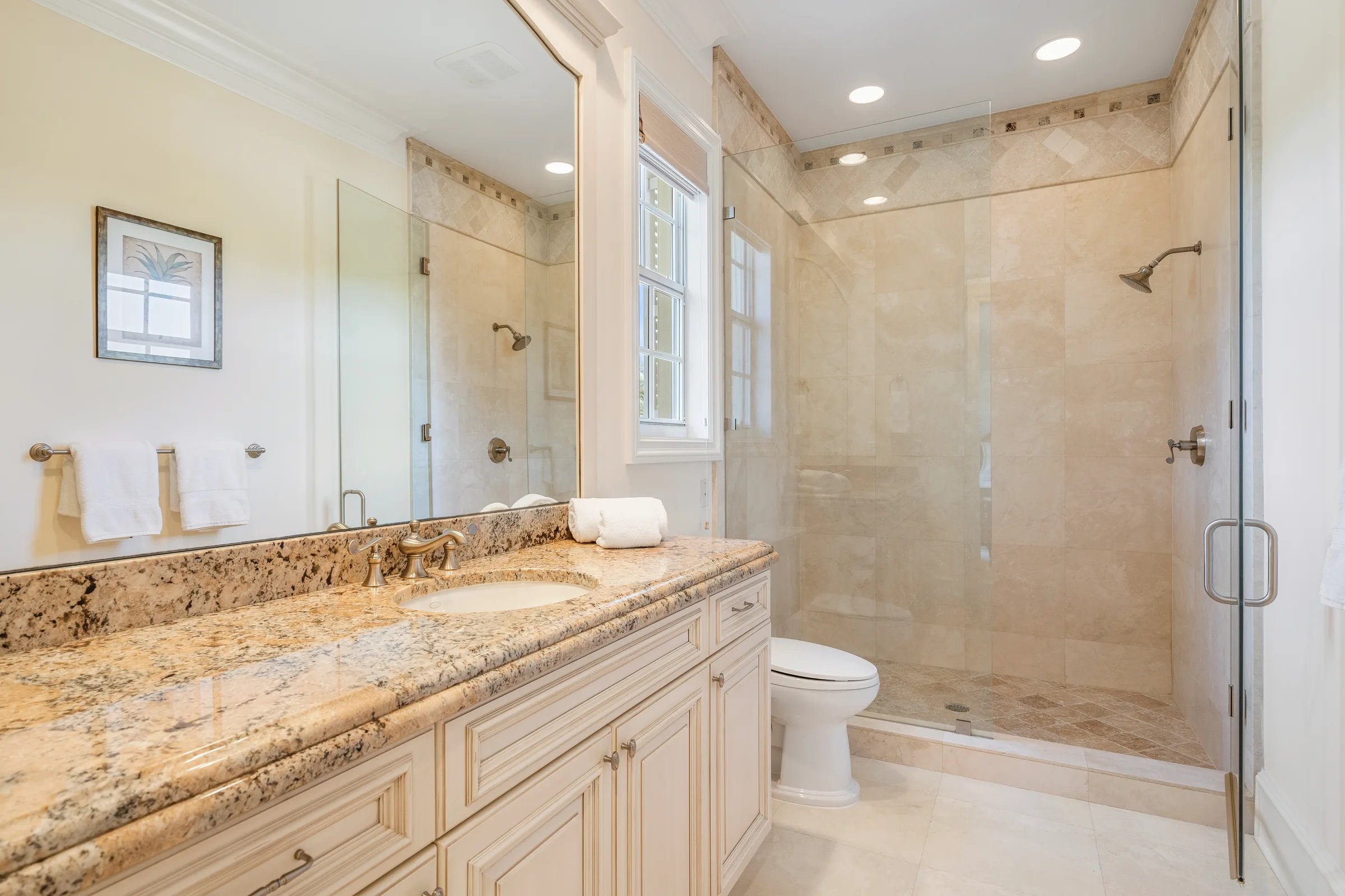 Guest ensuite bath with long stone vanity and walk-in shower