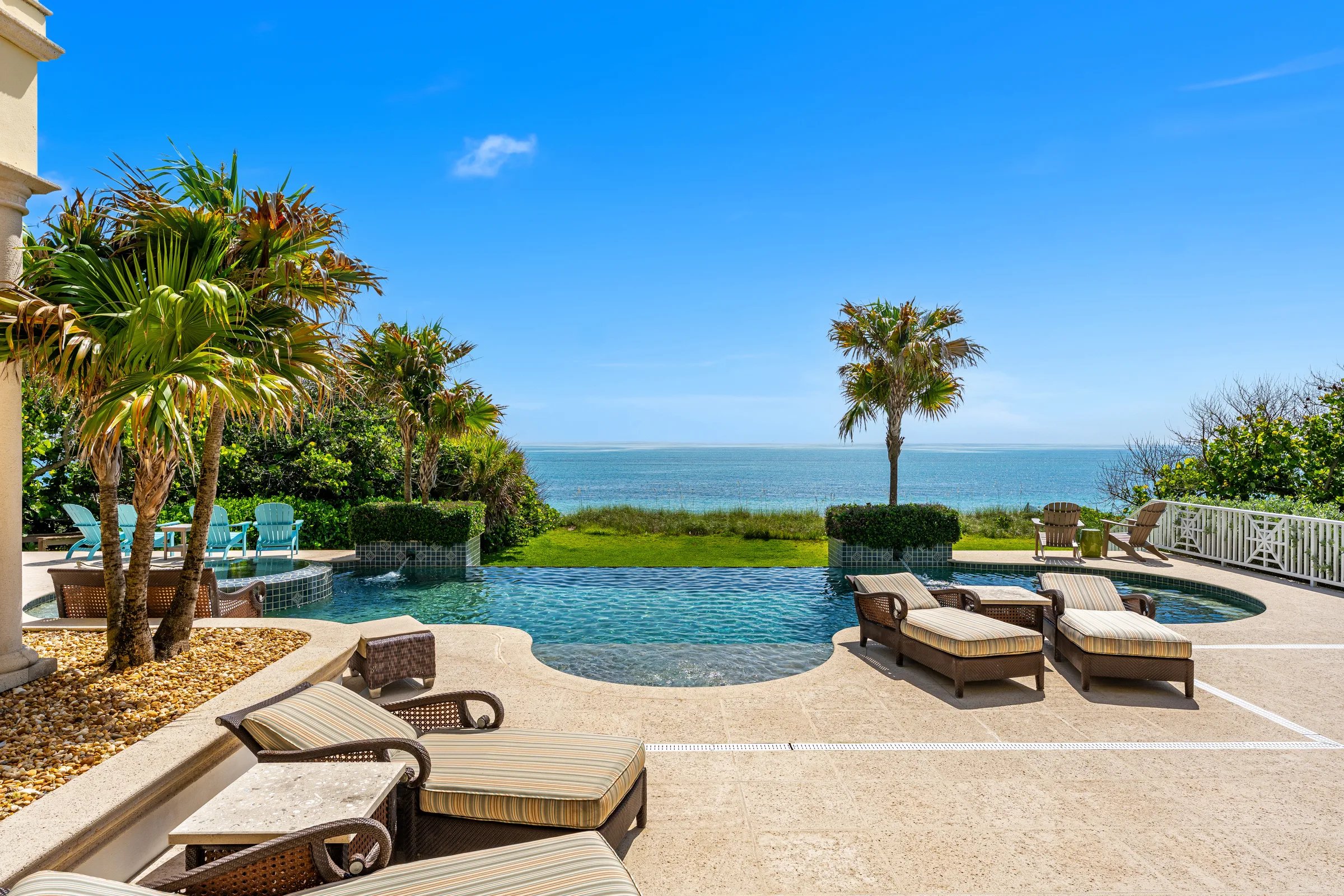 Infinity-edge pool and spa dissolving into the Atlantic horizon at midday