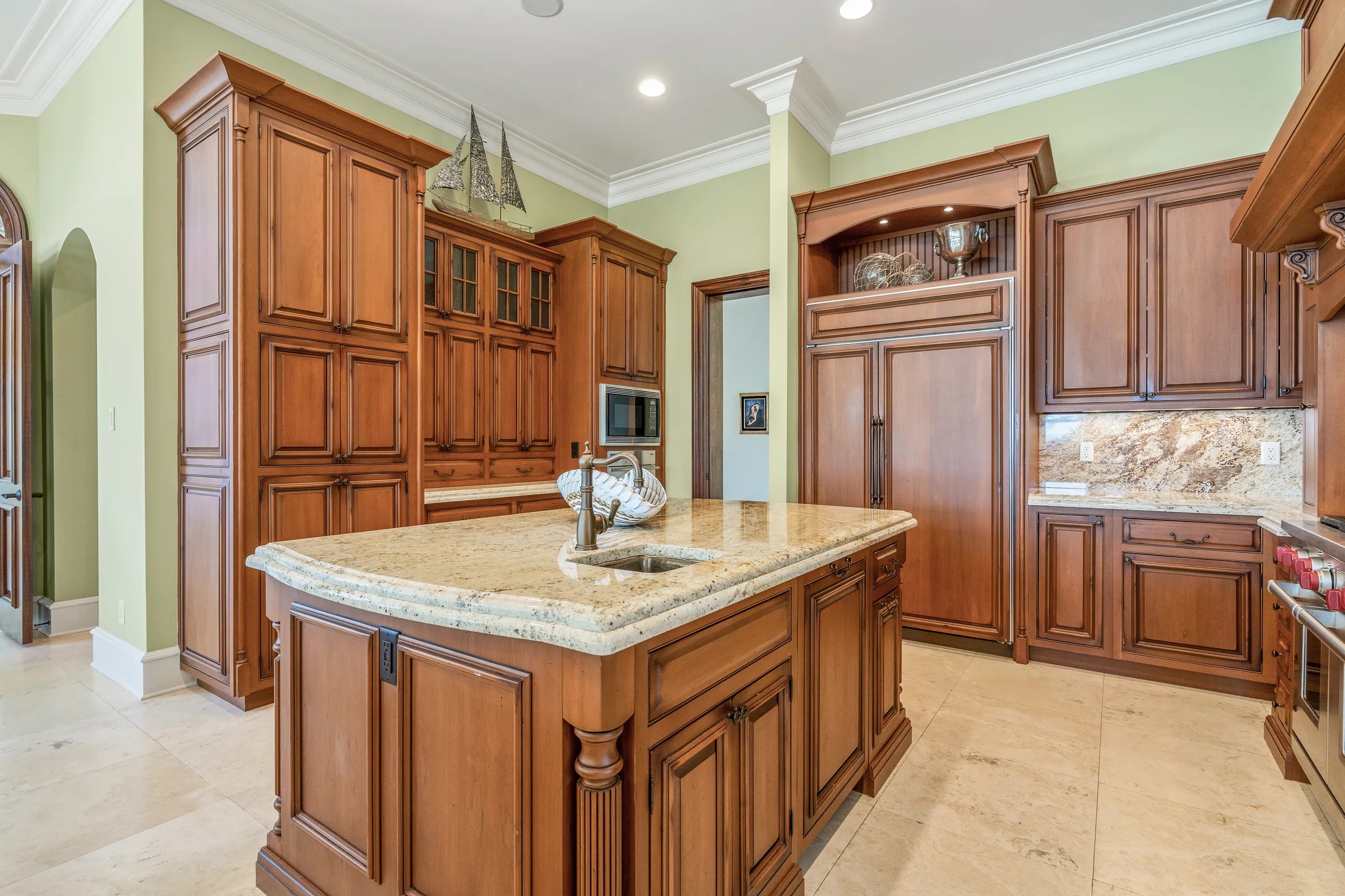 Granite prep island with cherry cabinetry