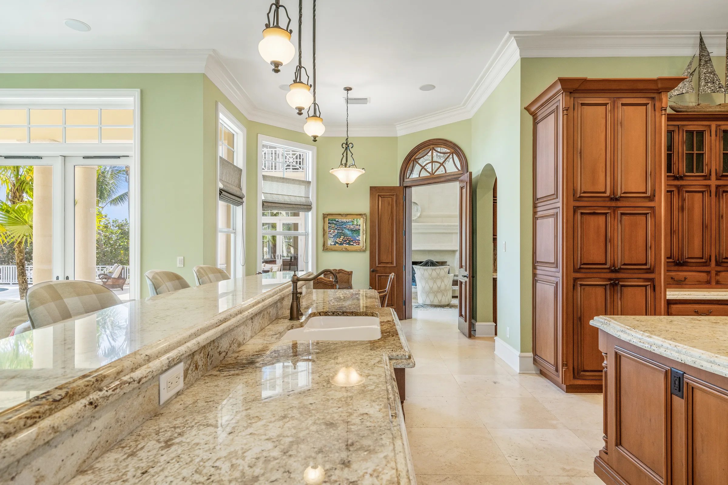 Chef's kitchen range area in a bay-window alcove with cherry cabinetry at 211 Beachside Drive in Orchid, Florida