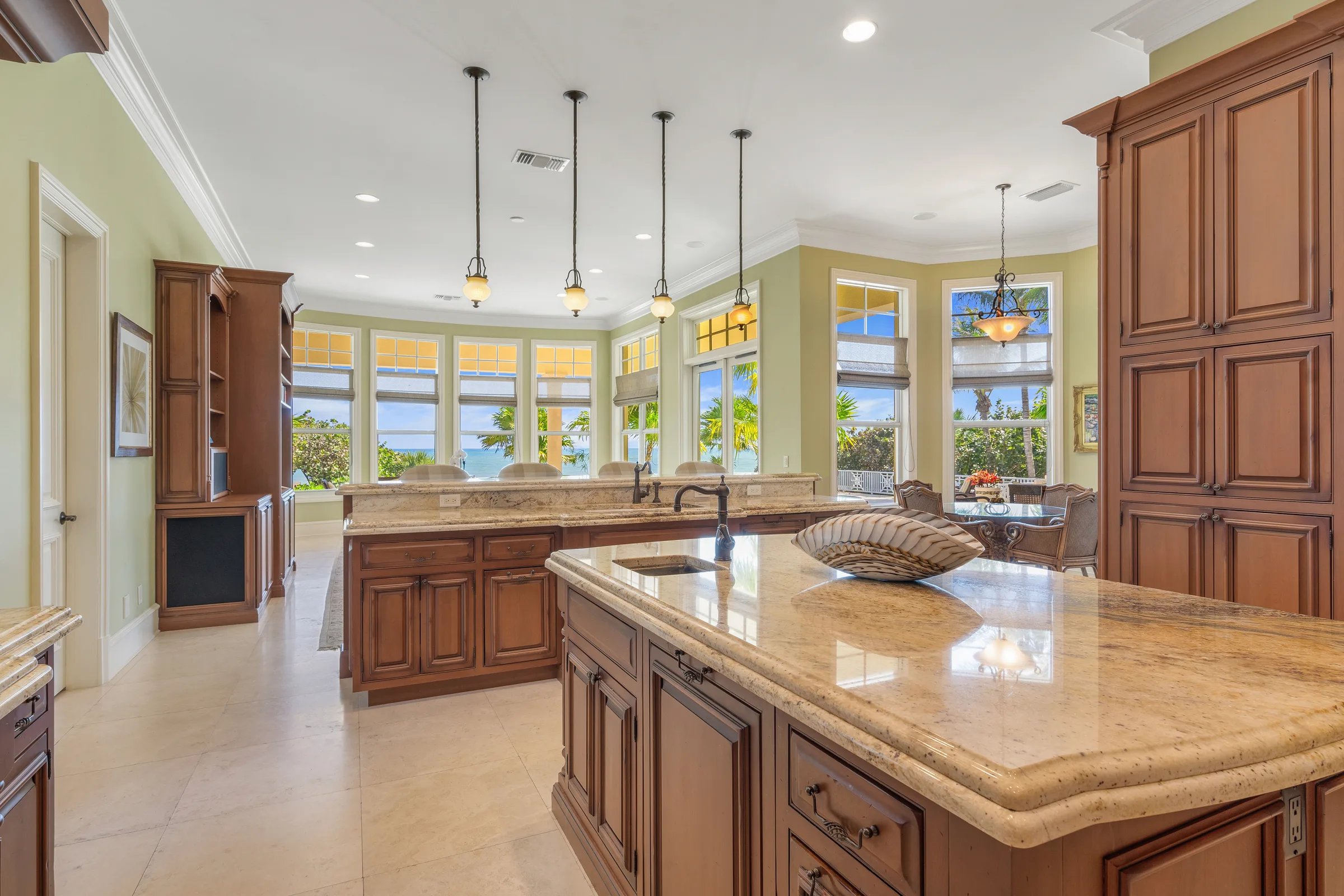 Kitchen wide with pendants and ocean glimpse