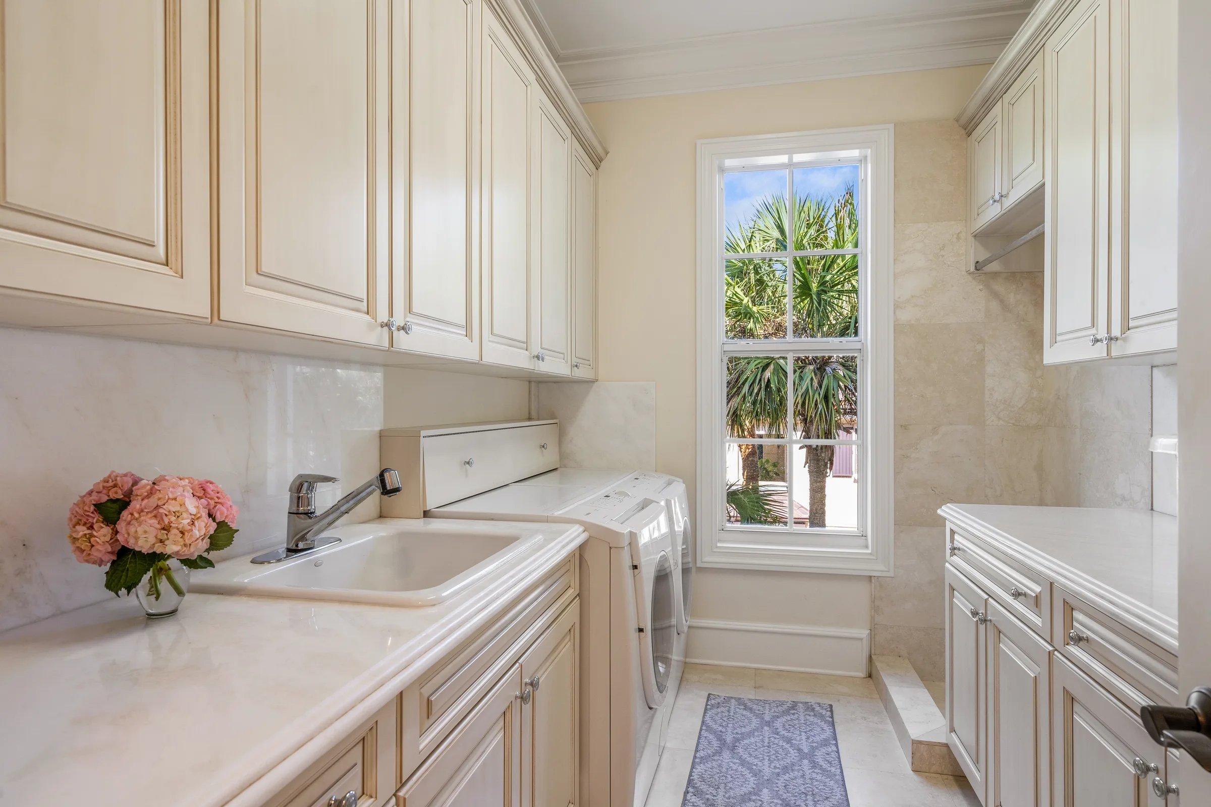 Galley laundry with marble counters and bay window