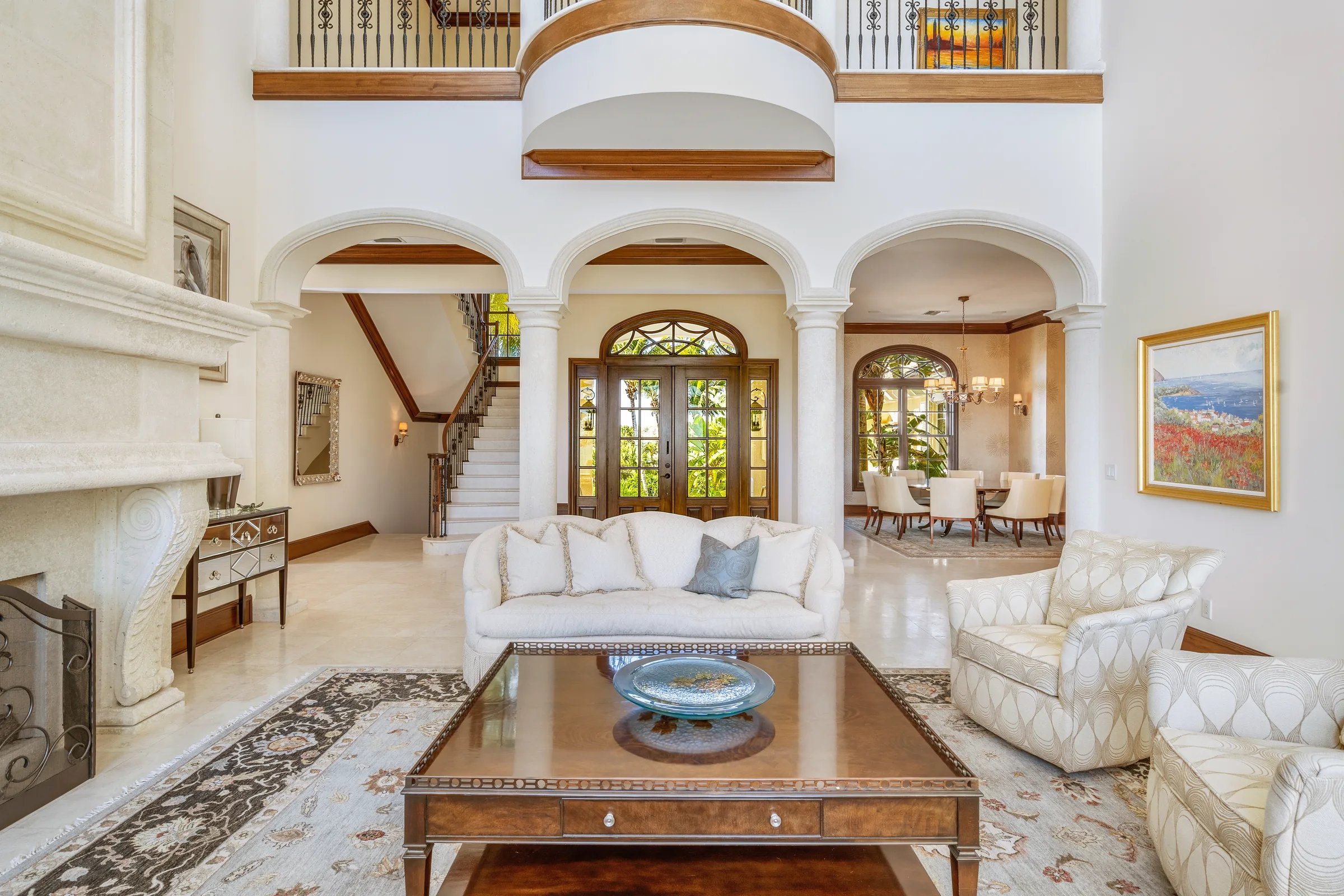 Great room with fireplace and curved staircase