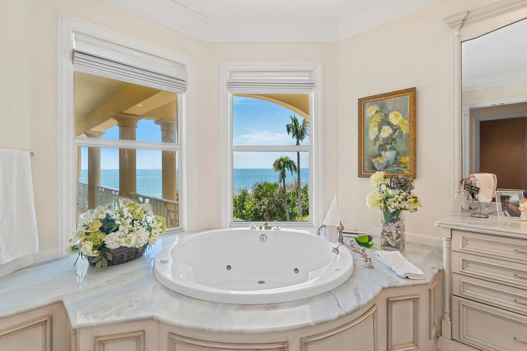Owner bath jetted soaking tub framed by bay windows overlooking the Atlantic