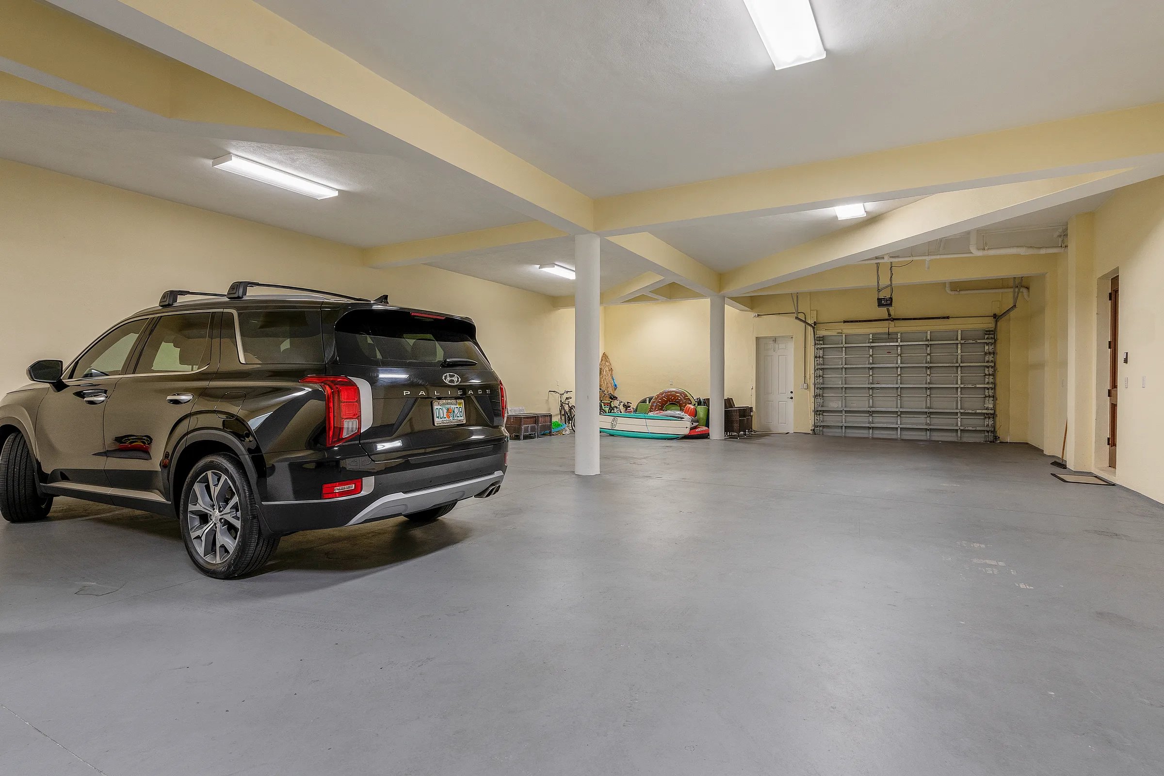 Climate-controlled five-car drive-through garage on the lower level at 211 Beachside Drive in Orchid, FL