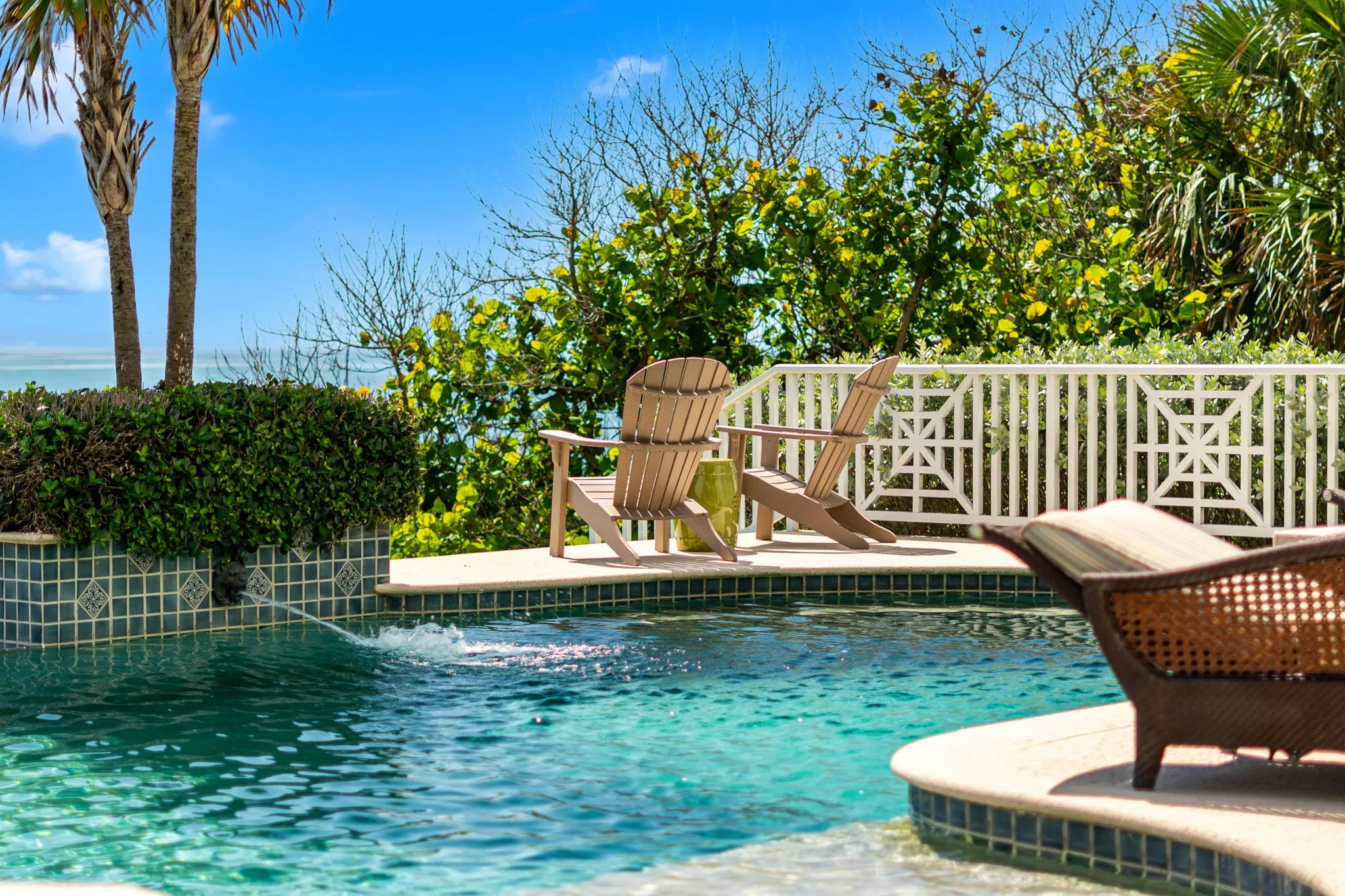 Adirondack chairs sit beside the spillover pool above the Atlantic dune